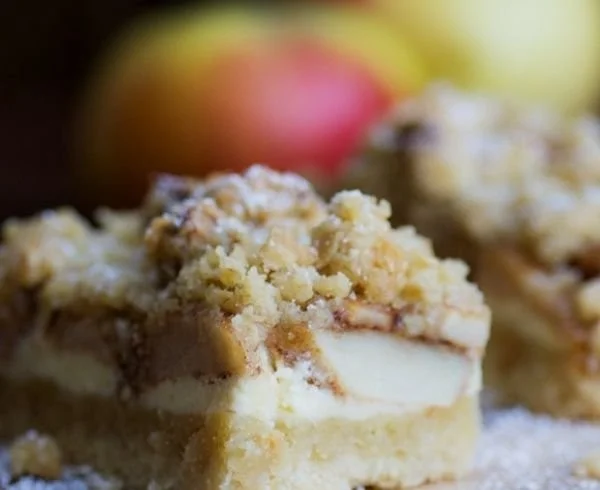 Apfel-Cheesecake mit Walnuss-Streuseln und Karamellsauce auf einem Teller